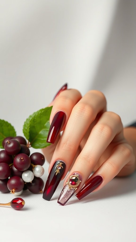 Close-up of cherry wine nails with jewel tones and decorative accents.