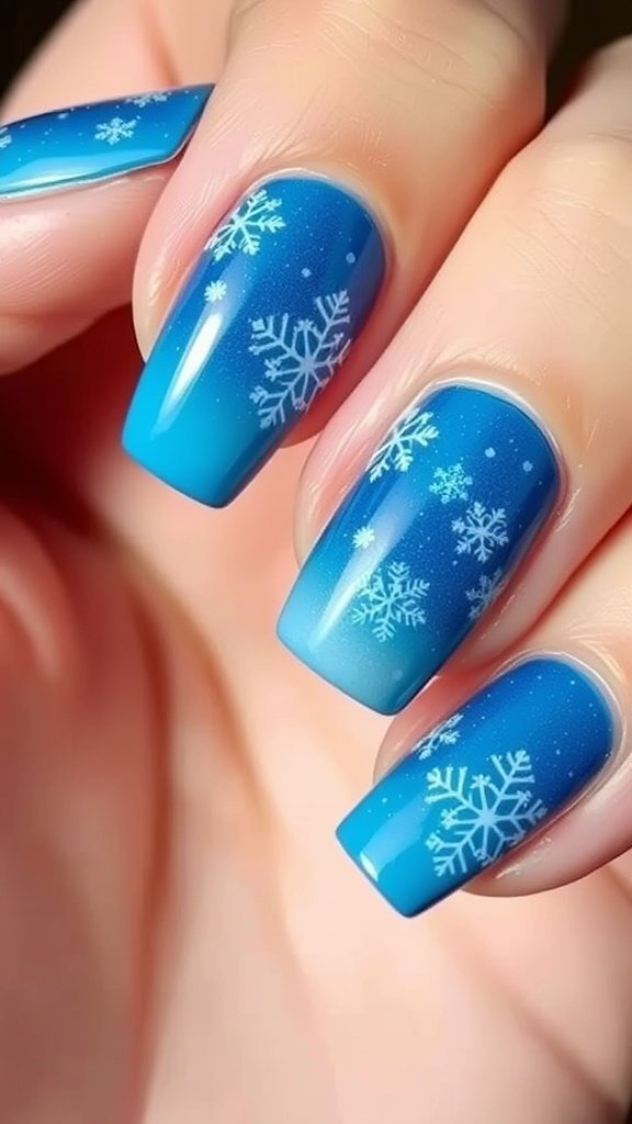 Nails featuring an icy blue ombre design with white snowflakes.